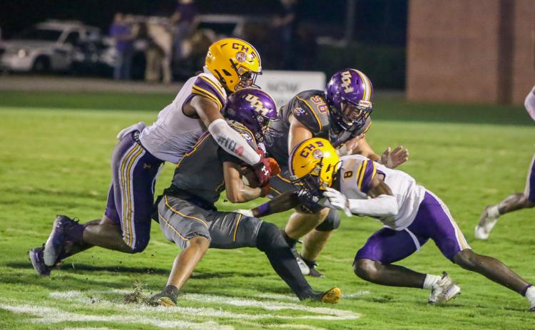 Columbia High linebacker Tyrell Peterson (left) and defensive back Jaylen Cooper converge on a Union County ballcarrier last week. The Tigers are looking to pick up their first win of the season when Deland visits Tiger Stadium tonight. (BRENT KUYKENDALL/Lake City Reporter)