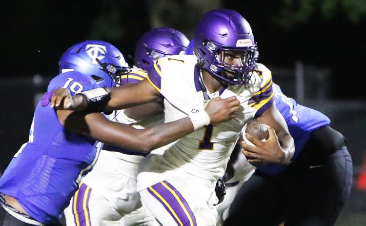 Columbia quarterback Tyler Jefferson fights through a tackle from Trinity Christian linebacker Tomarion McCray on Friday. (BRENT KUYKENDALL/Lake City Reporter)