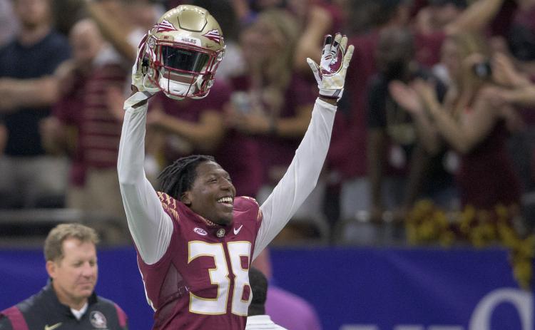 Florida State defensive back Shyheim Brown (38) celebrates a dropped punt catch by LSU and recovery by Florida State in the second half of Sunday’s game in New Orleans. Brown would later seal Florida State’s 24-23 victory by blocking an extra point kick attempt by LSU. (MATTHEW HINTON/Associated Press)
