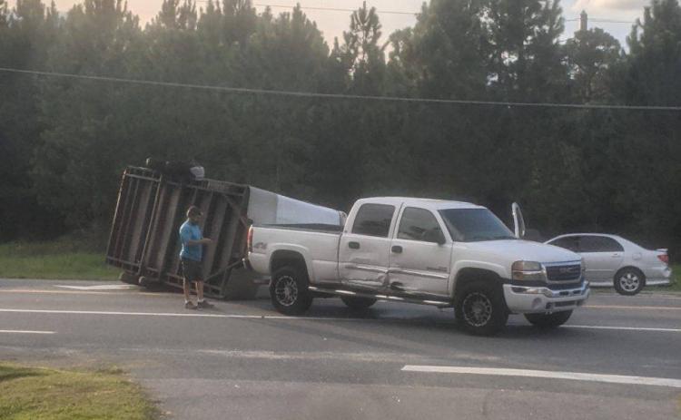 A trailer lies overturned on Branford Highway (State Road 247) on Tuesday evening after a crash following an improper U-Turn. (COURTESY GLENN ALLEN)