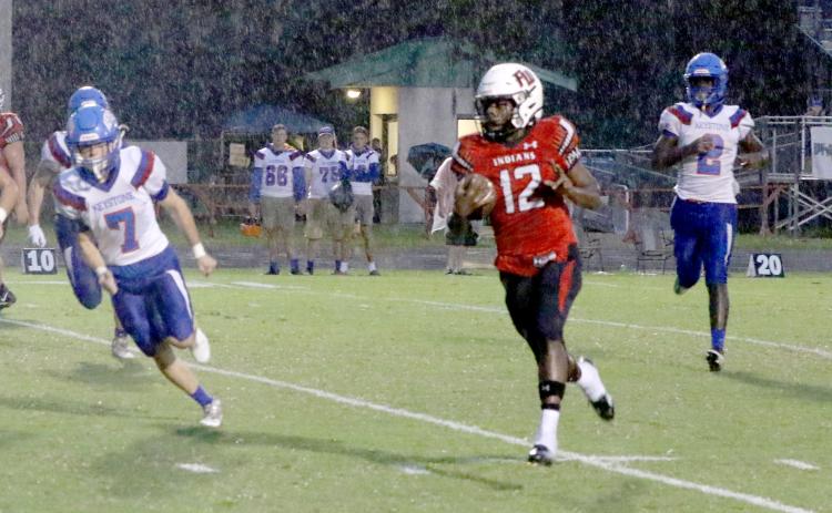 Fort White’s Najeeb Smith throws up a peace sign on his first rushing touchdown Friday night against Keystone Heights. (MORGAN MCMULLEN/Lake City Reporter)