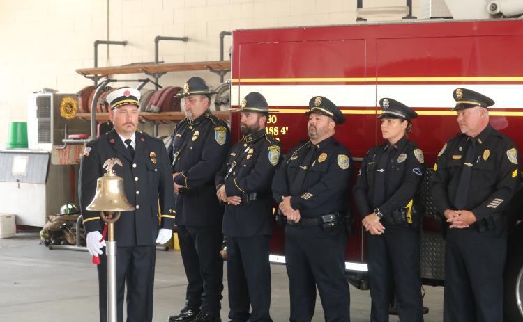 Lt. Robert Oliver, a Lake City Fire Department firefighter, rings a bell to commemorate the moments when airliners crashed into the World Trade Center Buildings during a Patriot Day Memorial Ceremony on Friday morning. (TONY BRITT/Lake City Reporter)