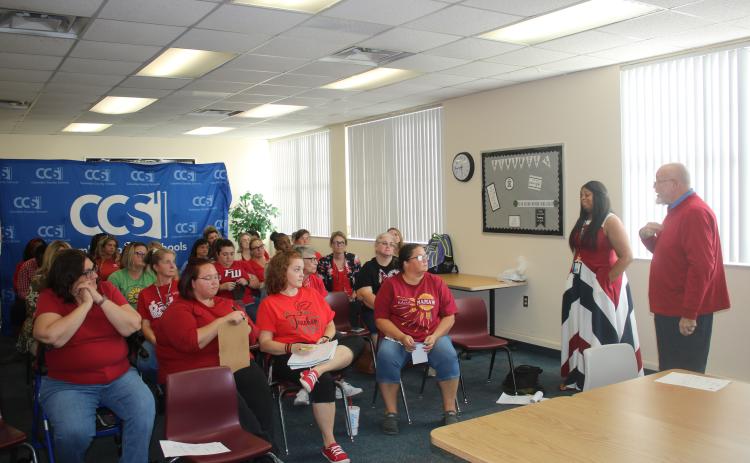 Mickey Garrett (right), a Pathways Academy instructor and Columbia Teachers Association negotiator, speaks to a group of educators Thursday afternoon. (TONY BRITT/Lake City Reporter)