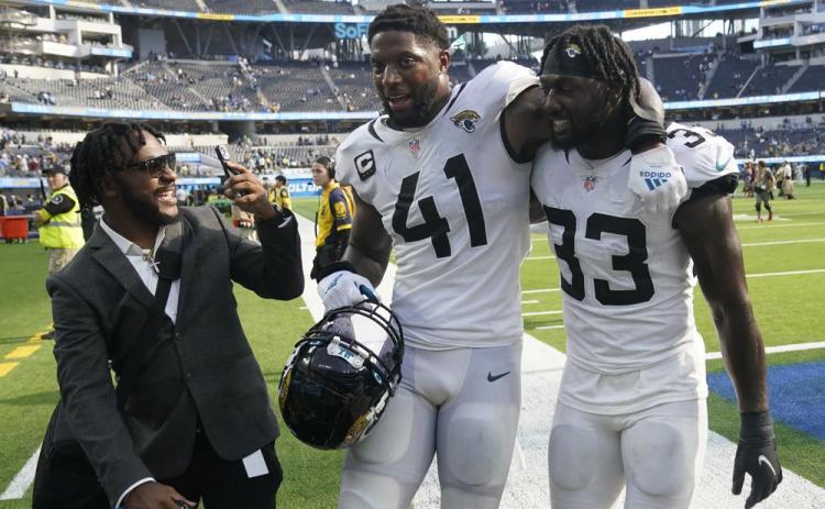 Jacksonville Jaguars linebacker Josh Allen (41) and linebacker Devin Lloyd (33) walk off the field after Sunday's win over the Los Angeles Chargers in Inglewood, Calif. (MARCIO JOSE SANCHEZ/Associated Press)
