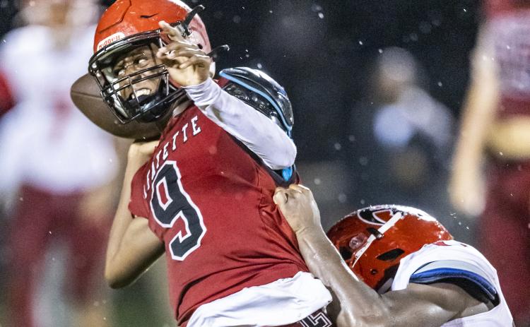 Lafayette quarterback Tywan Williamson avoids a sack by throwing the ball away against Hamilton County on Friday. (JACK HOWDESHELL/Special to the Reporter)