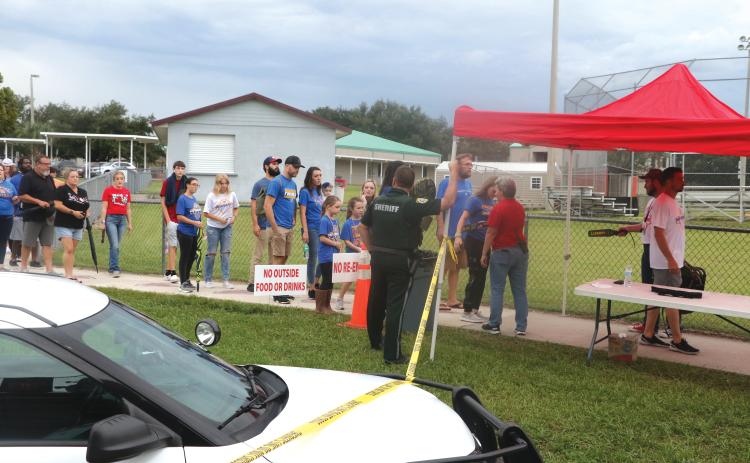 Visitors at last Friday’s Fort White-Newberry football game are searched for weapons and any other hazardous materials on their way into Arrowhead Stadium at Fort White High School. (MORGAN MCMULLEN/Lake City Reporter)