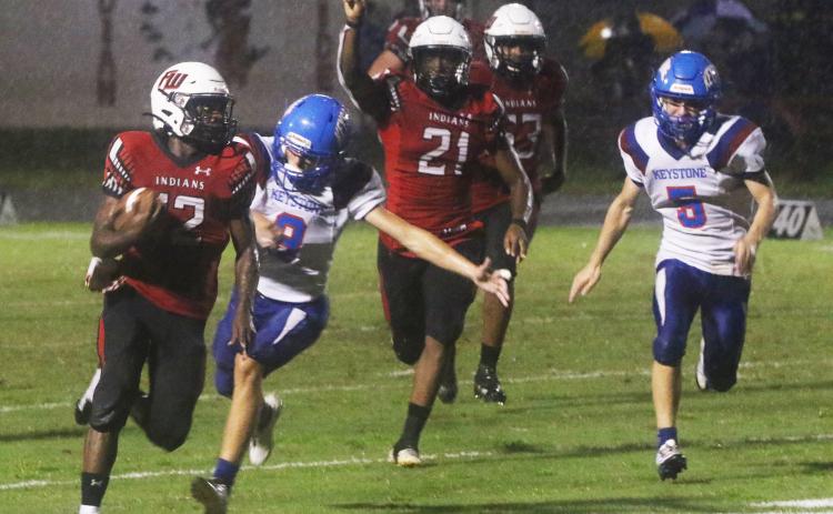 Fort White receiver Najeeb Smith rushes up the field ahead of Keystone Heights’ Wyatt Van zant on Friday. (MORGAN MCMULLEN/Lake City Reporter)