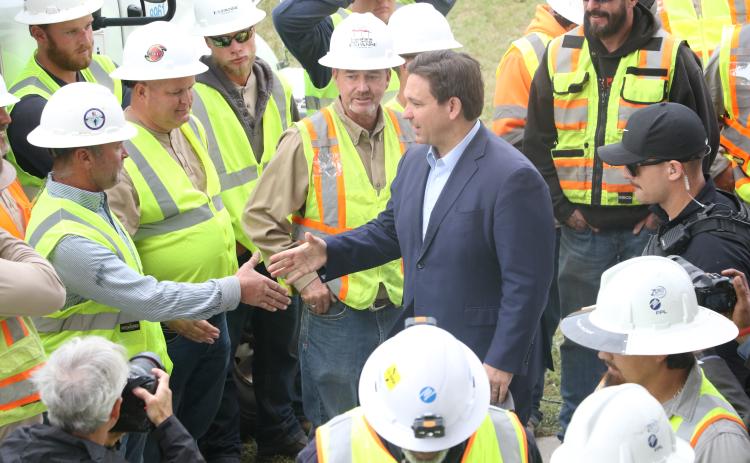 Gov. Ron DeSantis shakes hands with linemen at the Florida Power & Light processing site at the Florida Gateway Fairgrounds on Wednesday morning following a press conference to address Hurricane Ian. (MORGAN MCMULLEN/Lake City Reporter)