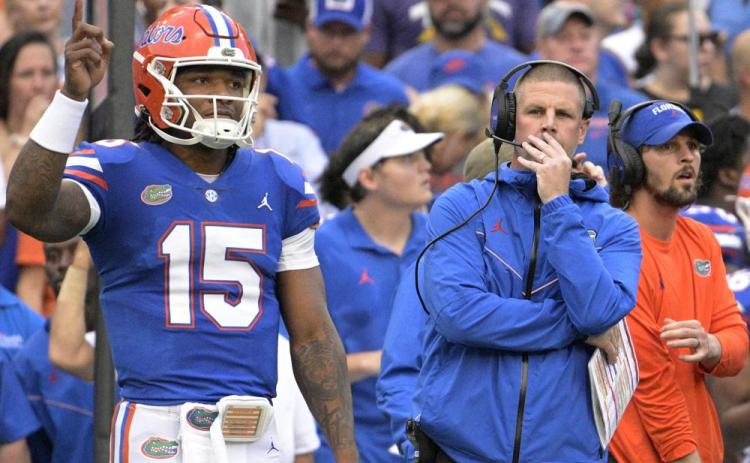 Florida coach Billy Napier (right) and quarterback Anthony Richardson (15) watch from the sideline during Saturday's game against Utah in Gainesville. (PHELAN M EBENHACK/Associated Press)