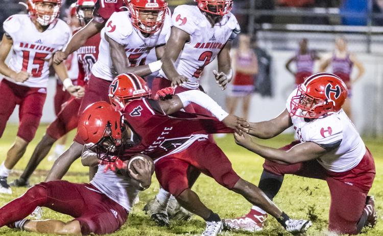 Lafayette running back Kiami McKnight is tackled by a host of Hamilton County defenders on Sept. 16. (JACK HOWDESHELL/Special to the Reporter)