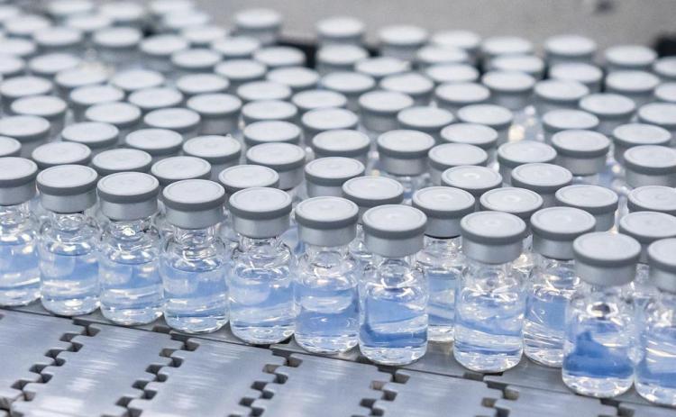 This August 2022 photo provided by Pfizer shows vials of the company’s updated covid-19 vaccine during production in Kalamazoo, Mich. (COURTESY/Pfizer via AP)