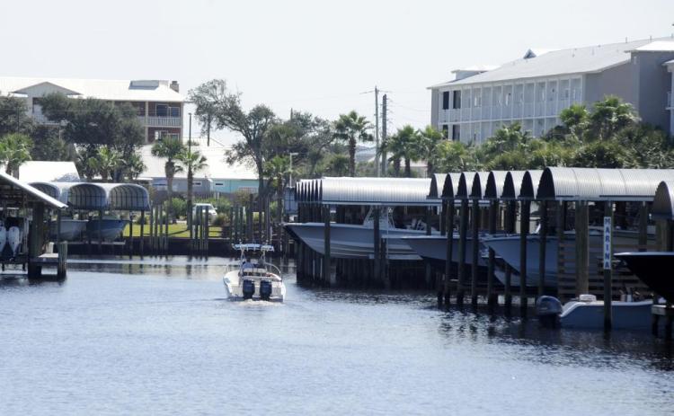 A boat cruises through a marina in rebuilt Mexico Beach on Oct. 11. Destroyed by Hurricane Michael, the Florida Panhandle community is still rebuilding four years later. (JAY REEVES/Associated Press)