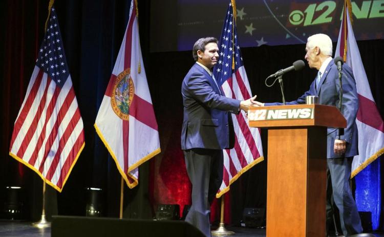 Florida’s Republican Gov. Ron DeSantis (left) and Democratic opponent Charlie Crist take to the stage for their only scheduled debate in Fort Pierce Monday. (CRYSTAL VANDER WEIT/TCPalm.com via AP)