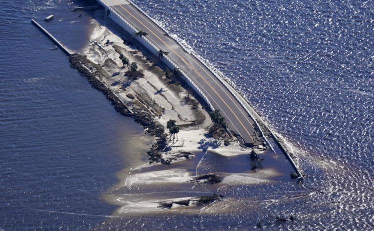 In this aerial photo made in a flight provided by mediccorps.org, damage from Hurricane Ian is seen on the causeway leading to Sanibel Island from Fort Myers on Sept. 30. (GERALD HERBERT/AP File)