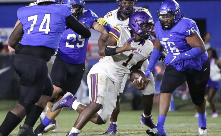 Columbia quarterback Tyler Jefferson scrambles for yardage as Trinity Christian defensive lineman Nick Williams gives chase on Sept. 23. (BRENT KUYKENDALL/Lake City Reporter)