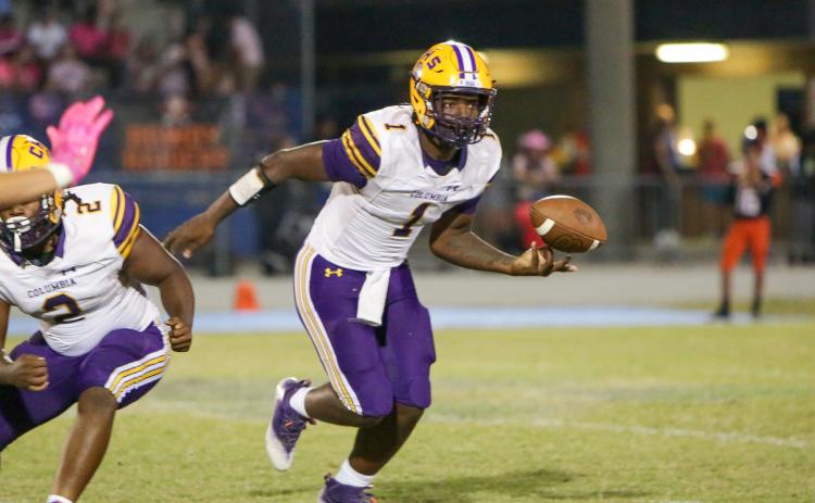 Columbia quarterback Tyler Jefferson flips the ball to a teammate during Friday’s game against Orange Park. (BRENT KUYKENDALL/Lake City Reporter)