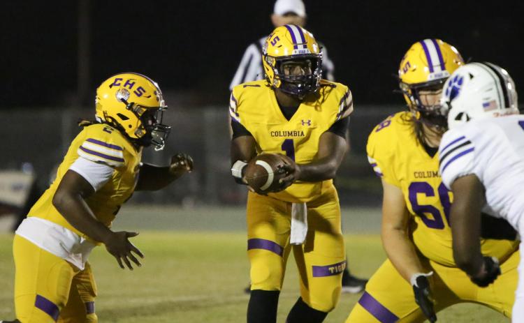 Columbia quarterback Tyler Jefferson hands the ball off against Ridgeview on Friday night. (BRENT KUYKENDALL/Lake City Reporter)
