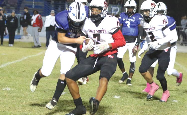 Fort White defensive back Tafari Moe runs after an interception against Ridgeview last Friday. (MORGAN MCMULLEN/Lake City Reporter)