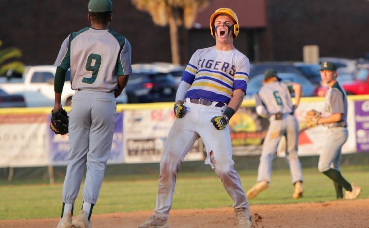 Columbia’s Hayden Gustavson celebrates after reaching second base against Lincoln in last season’s regional final. (BRENT KUYKENDALL/Lake City Reporter)