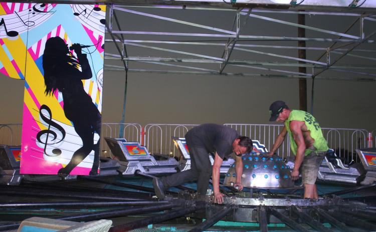 Andrew Mielke sets up panels for the Music Fest ride on Wednesday evening at the Florida Gateway Fairgrounds. The 68th annual Florida Gateway Fair begins Friday afternoon. (TONY BRITT/Lake City Reporter)