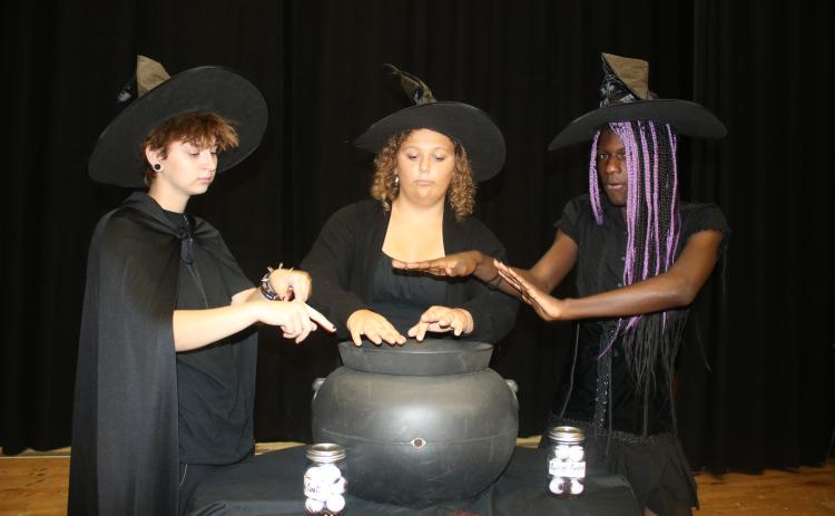 Van Morrison (from left), Rebecca Beer and Khalil Cleckley rehearse during a scene where they portray witches conjuring a spell in, ‘Vampire Diaries — The Original.’ (TONY BRITT/Lake City Reporter)