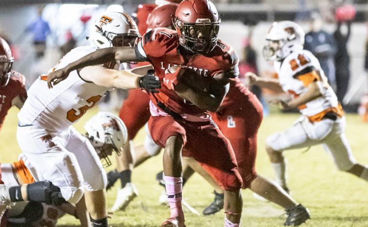 Lafayette running back Kiami McKnight run past a Trenton tackler last Friday. (JACK HOWDESHELL/Special to the Reporter)