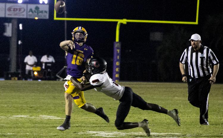Columbia quarterback Evan Umstead throws a pass out of defensive pressure against Middleburg on Friday. (JEN CHASTEEN/Special to the Reporter)