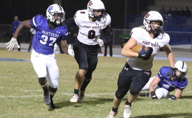 Fort White fullback Hayden Adams rushes past the Ridgeview defense on Friday night. (MORGAN MCMULLEN/Lake City Reporter)