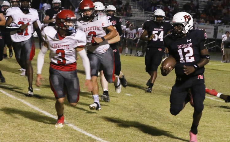 Fort White running back Najeeb Smith eyes Lafayette safety Baylor Johnson on a run Friday night at Arrowhead Stadium. (MORGAN MCMULLEN/Lake City Reporter)