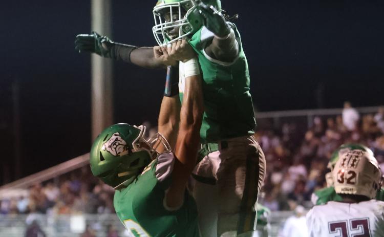Suwannee receiver Kodi Lang (left) raises up running back Marquavious Owens as the two celebrate following Owens’ touchdown against Madison County on Oct. 14. (PAUL BUCHANAN/Special to the Reporter)