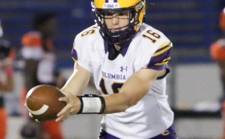 Columbia quarterback Evan Umstead turns to hand the ball off during Friday’s game against Orange Park. (BRENT KUYKENDALL/Lake City Reporter)