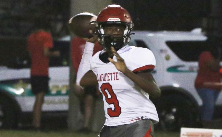 Lafayette quarterback Tywan Williamson sets to throw a pass against Fort White last Friday. (MORGAN MCMULLEN/Lake City Reporter)
