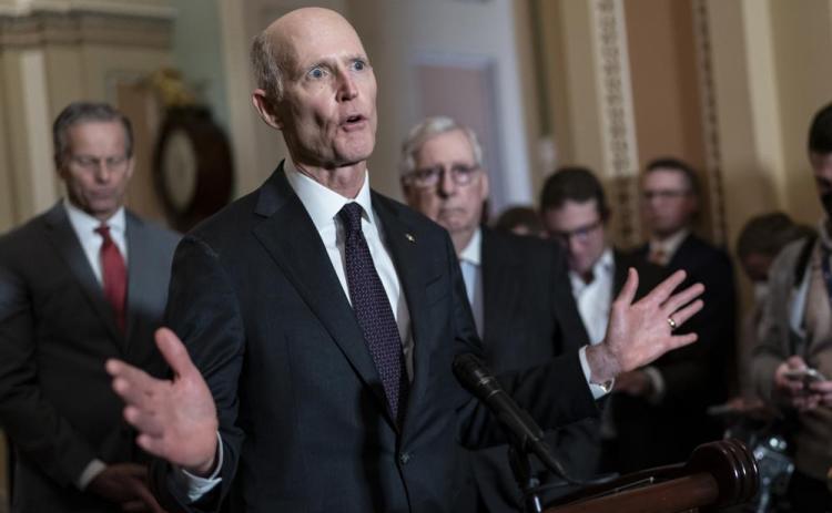 Sen. Rick Scott, R-Fla., speaks as Senate Minority Leader Mitch McConnell, R-Ky., listens at right during a news conference at the Capitol in Washington. (J. SCOTT APPLEWHITE/AP File)