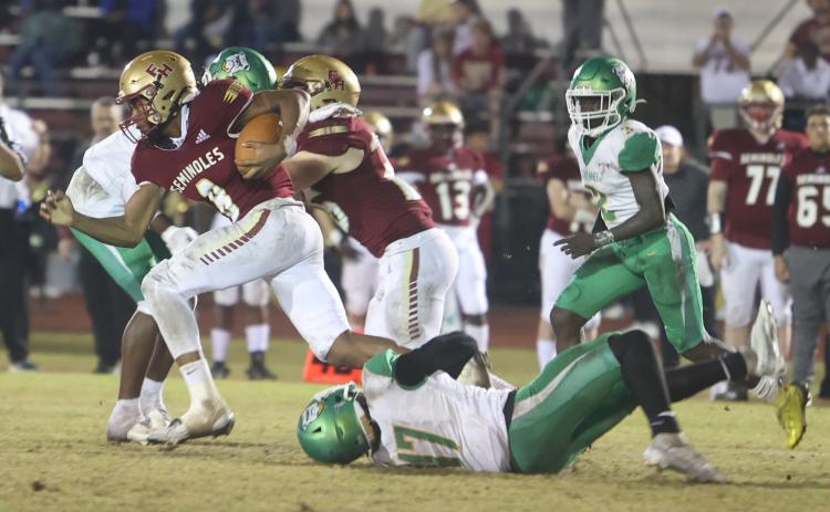 Florida High running back Micahi Danzy escapes a tackle by Suwannee linebacker Delwyn Allen during Friday’s Region 1-2S final. (PAUL BUCHANAN/Special to the Reporter)