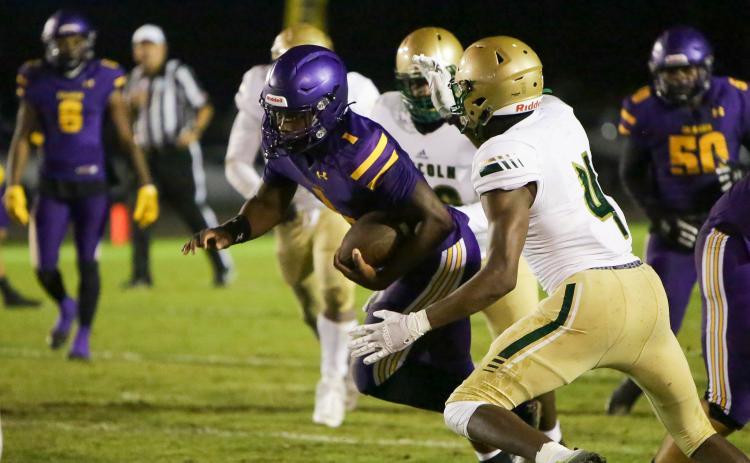 Columbia quarterback Tyler Jefferson scrambles for yardage against Lincoln in the Region 1-3S quarterfinals last Friday. (BRENT KUYKENDALL/Lake City Reporter)