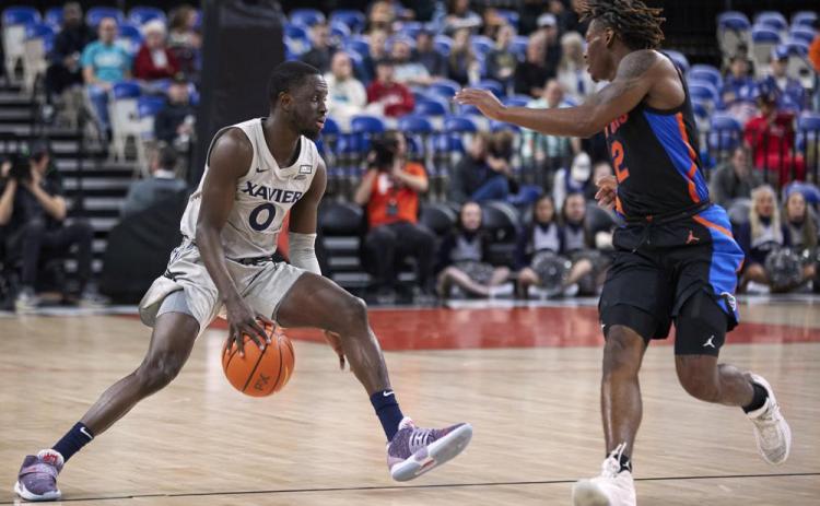Xavier guard Souley Boum (left) is defended by Florida guard Trey Bonham during the opening round of the Phil Knight Legacy on Thursday in Portland, Ore. (CRAIG MITCHELLDYER/Associated Press)