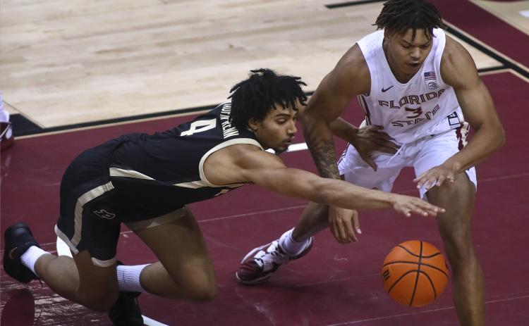 Purdue forward Trey Kaufman-Renn (4) and Florida State forward Cameron Corhen reach for the ball during Wednesday's game in Tallahassee. (PHIL SEARS/Associated Press)