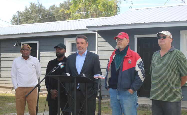James Hodges (second from right) listens as his attorney John M. Phillips speaks at Thursday’s press conference. (TONY BRITT/Lake City Reporter)