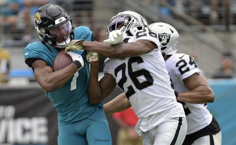 Jacksonville Jaguars wide receiver Zay Jones is stopped by Las Vegas Raiders cornerback Rock Ya-Sin during Sunday's in Jacksonville. (PHELAN M. EBENHACK/Associated Pres)
