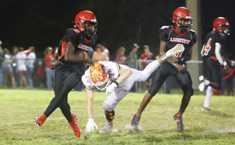 Lafayette running back Johntavious Cook runs past Branford defensive lineman Cole Certain on Oct. 17. (PAUL BUCHANAN/Special to the Reporter)