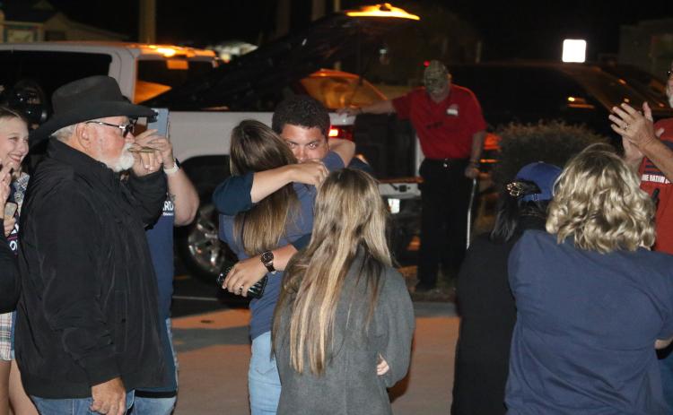 Hunter Peeler gets a hug from a supporter outside the Columbia County Supervisor of Elections Office on Tuesday night after winning the District 5 seat on the Columbia County School Board. (MORGAN MCMULLEN/Lake City Reporter)