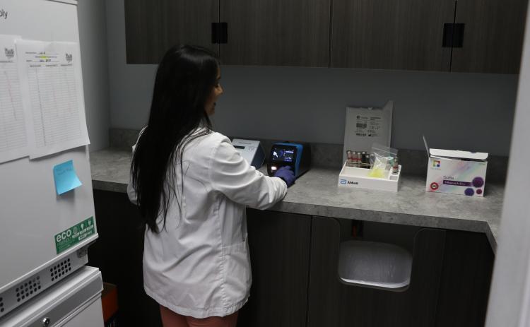 Dr. Shivani Mehta, the director of clinical services at Baya Pharmacy, performs a test on Monday. (MORGAN MCMULLEN/Lake City Reporter)