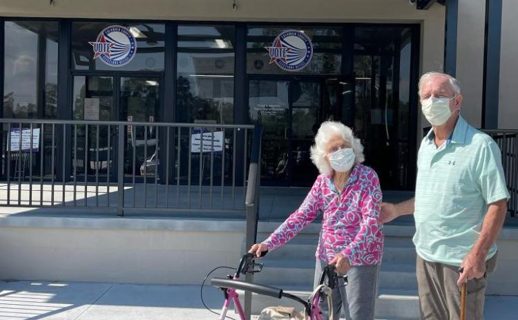 Helena Powers (left), a 106-year-old voter, makes time to cast her ballot alongside her son, Frank Powers (82). (COURTESY)