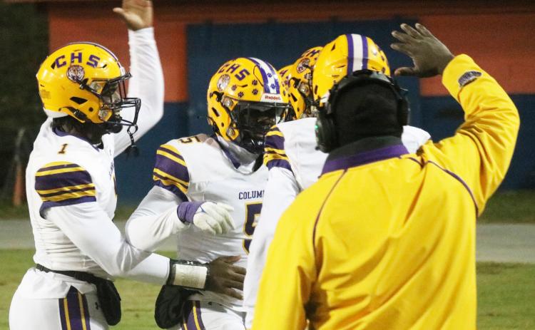 Columbia linebacker Jaden Robinson (5) celebrates with quarterback Tyler Jefferson (1) and others after scoring on a pick-6 against Escambia in the Region 1-3S semifinals on Friday. (JORDAN KROEGER/Lake City Reporter)