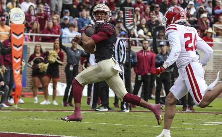 Florida State quarterback Jordan Travis runs for a touchdown against Louisiana on Nov. 19 in Tallahassee. (GARY MCCULLOUGH/Associated Press)