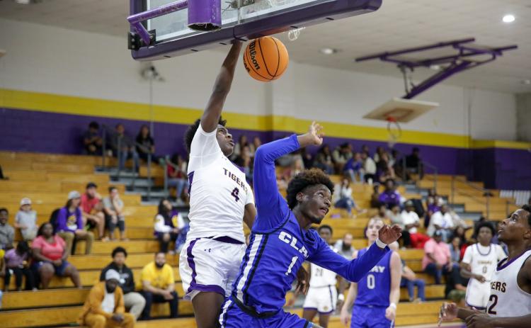 Columbia forward Ty’jahn Wright dunks on Clay wingman J’den Golding on Wednesday night. (BRENT KUYKENDALL/Lake City Reporter)