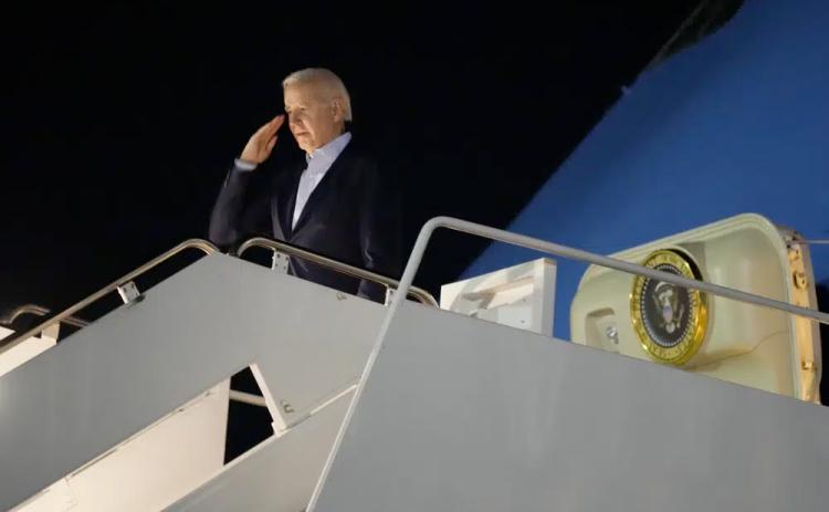 President Joe Biden salutes as he boards Air Force One at Andrews Air Force Base on Tuesday. Biden and his family are traveling to St. Croix, U.S. Virgin Islands, to celebrate New Year. (MANUEL BALCE CENETA/Associated Press)