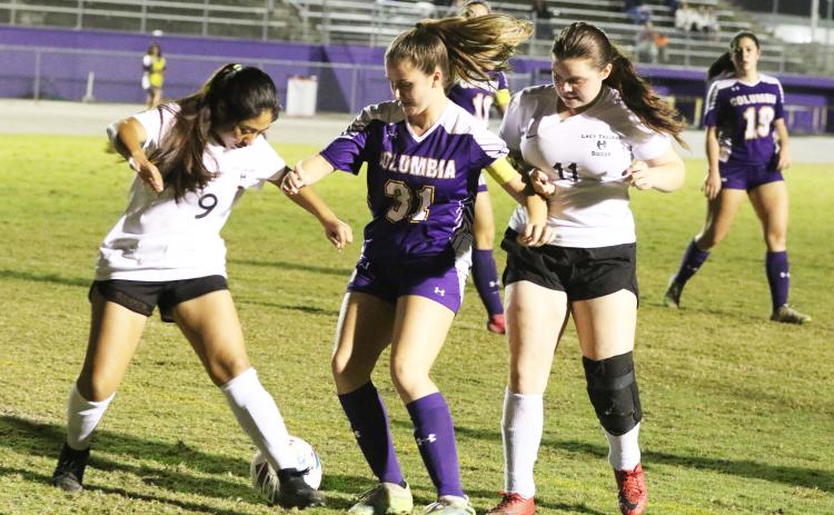 Columbia’s Sydney Rivas fights for possession of the ball with Hamilton County’s Joseline Garcia (9) and Malyiah Marcano (11) on Tuesday night. (MORGAN MCMULLEN/Lake City Reporter)
