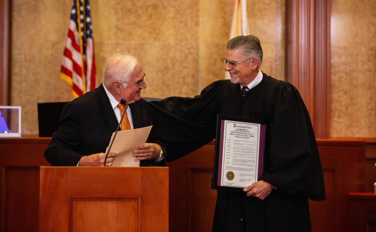 Lake City Mayor Stephen Witt (left) presents retired Third Judicial Circuit Judge Paul S. Bryan with a proclamation honoring Bryan for his three decades of service. (ESTA EBERHARDT/Special to the Reporter)