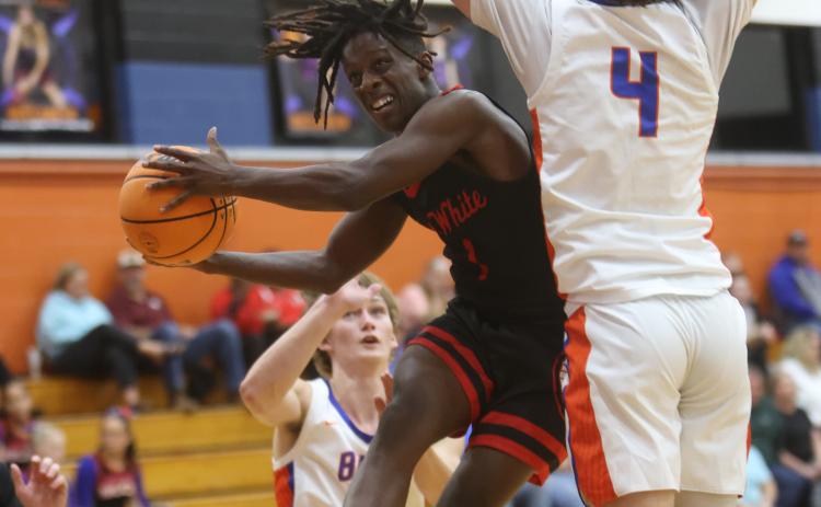 Fort White guard Najeeb Smith drives to shoot while being defend by Branford guard Camden Gaskins on Thursday night. (PAUL BUCHANAN/Special to the Reporter)